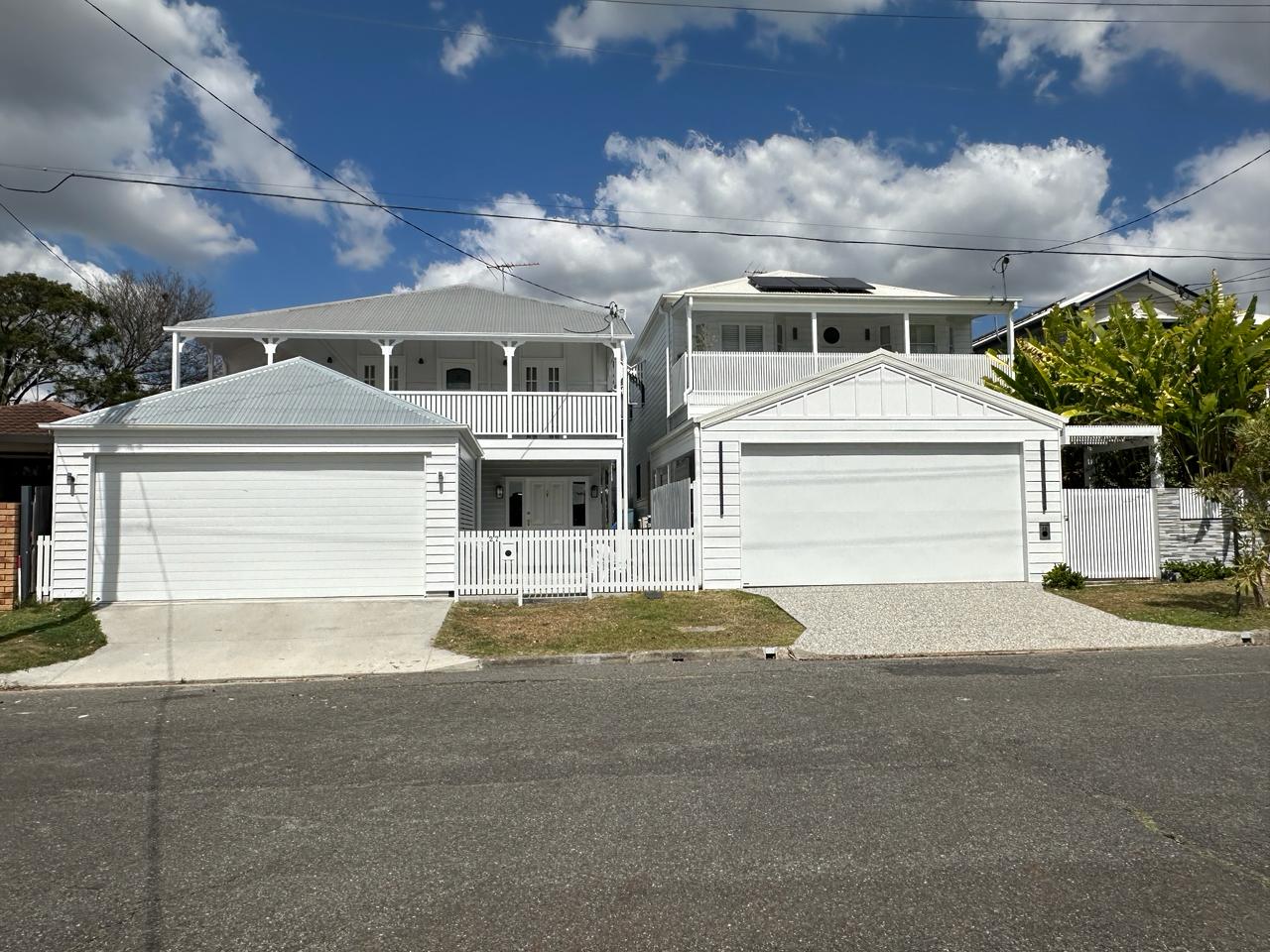 Freshly painted white two-storey Queenslander home in Brisbane